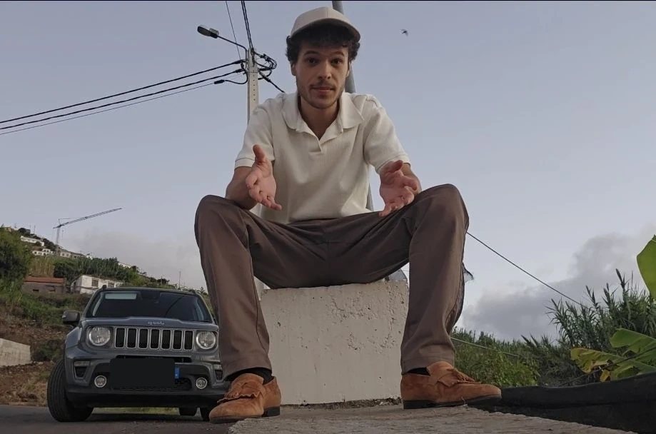 Alexander Thomas Goncalves-Soares seated outdoors